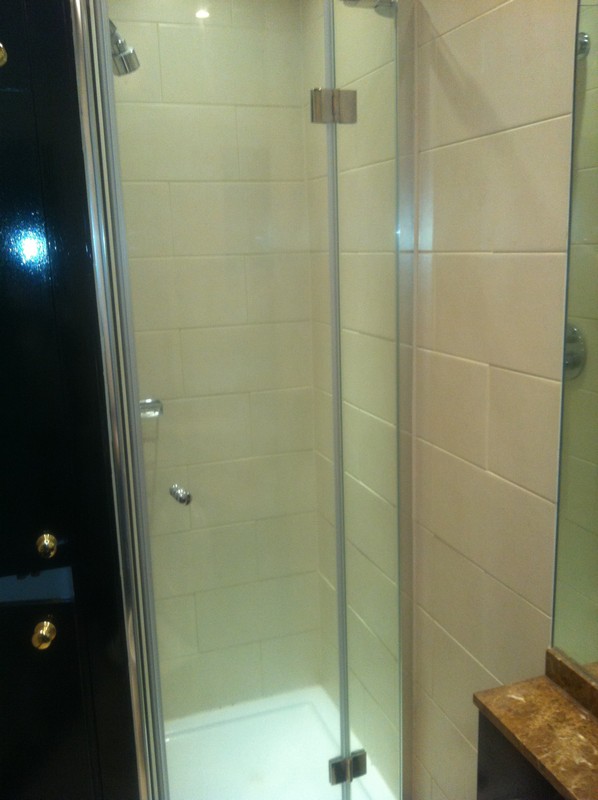 Frameless glass shower enclosure with chrome fittings in Finsbury Park