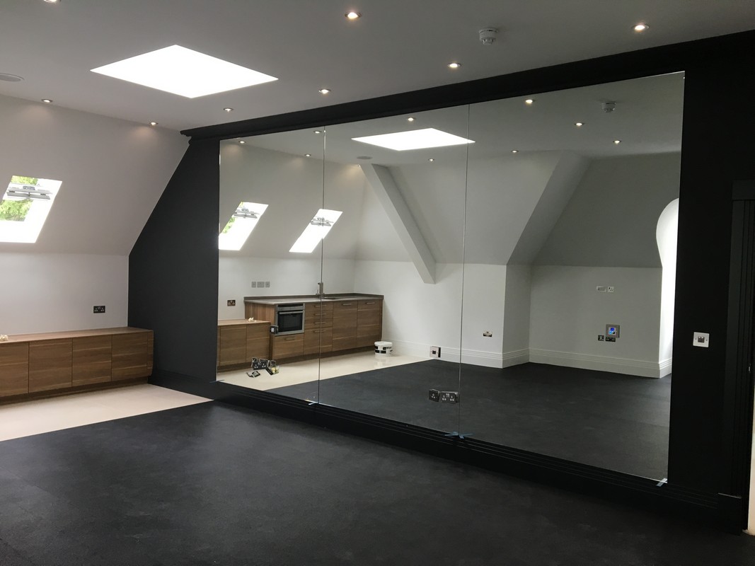 Frameless glass wall dividing loft conversion in Finsbury Park