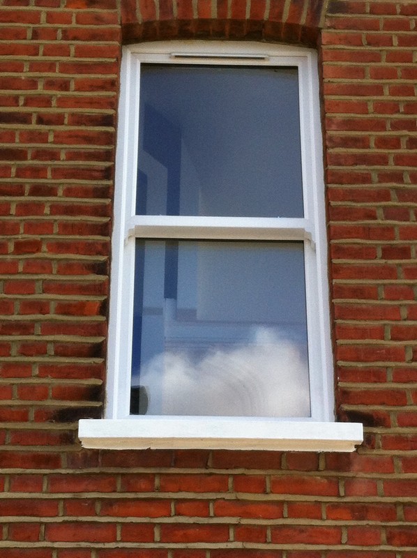 uPVC sash window on Victorian red brick house in Finsbury Park